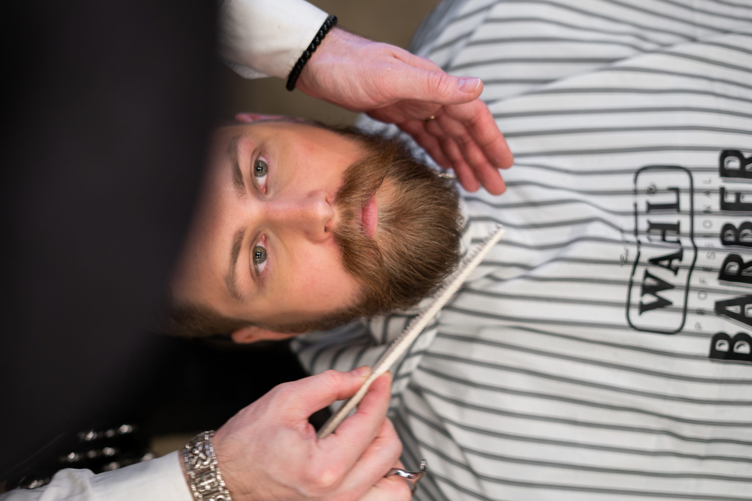 Barber servicing client with a Wahl cape